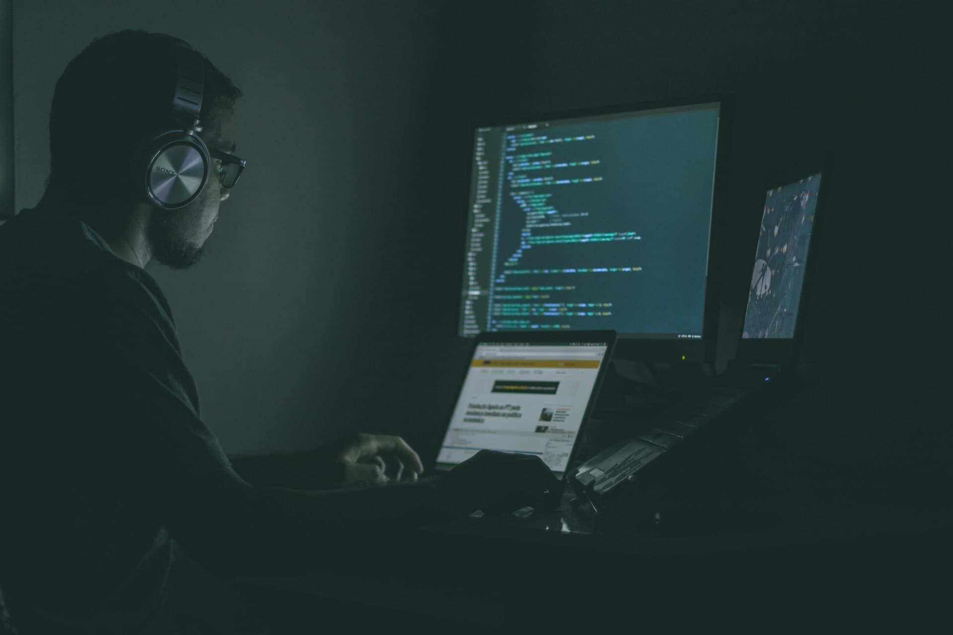 A programmer coding in a dark room
